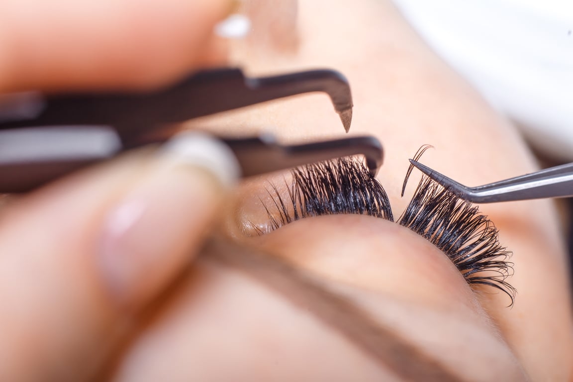 Eyelash Extension Procedure. Woman Eye with Long Eyelashes. Lashes.